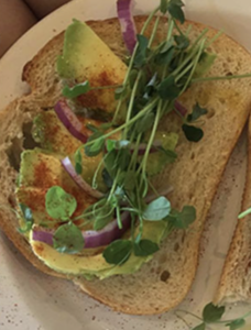 wheat toast with avocado and pea shoots